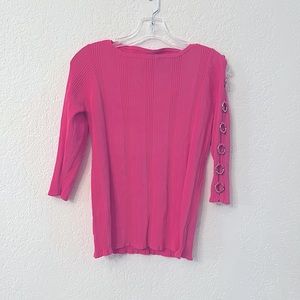 Pink Sweater with metal arm cutouts.